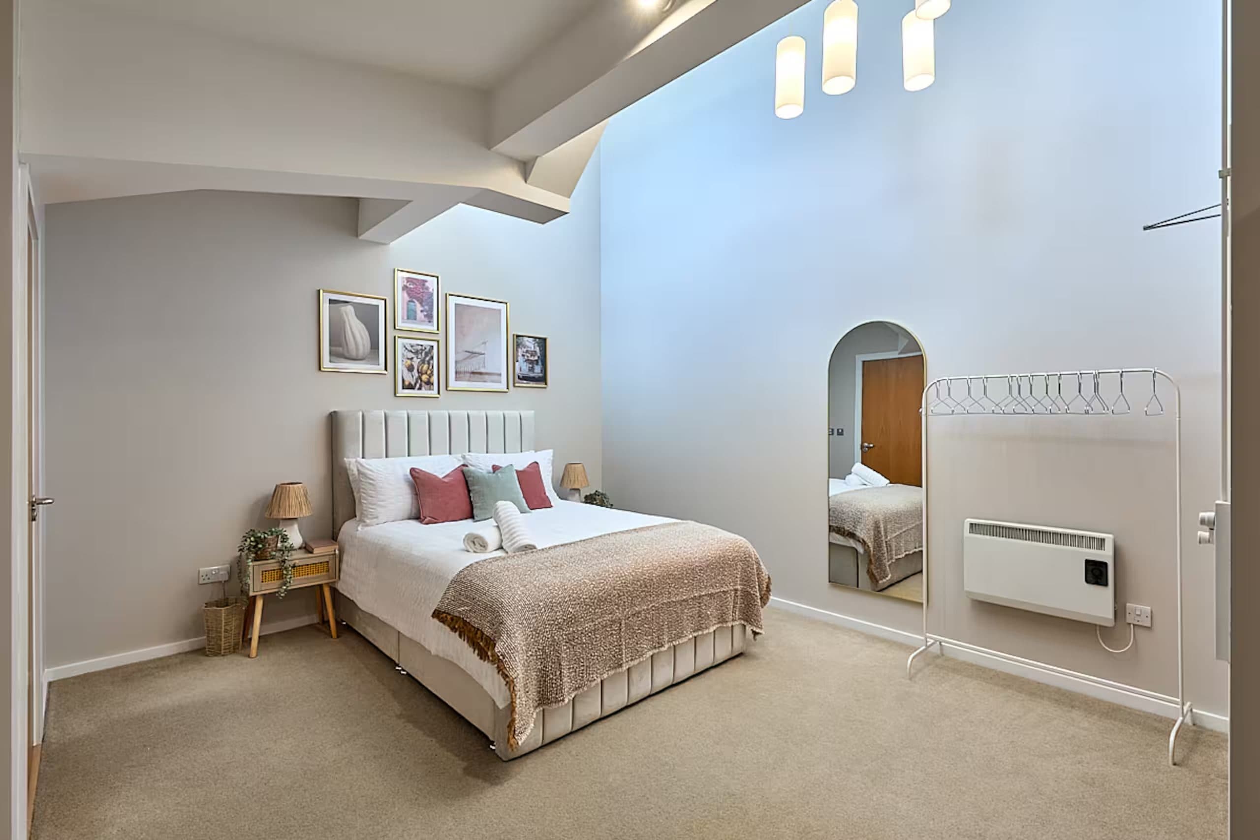 The apartment's bedroom made up for arrival, with fresh towels staged on the bed