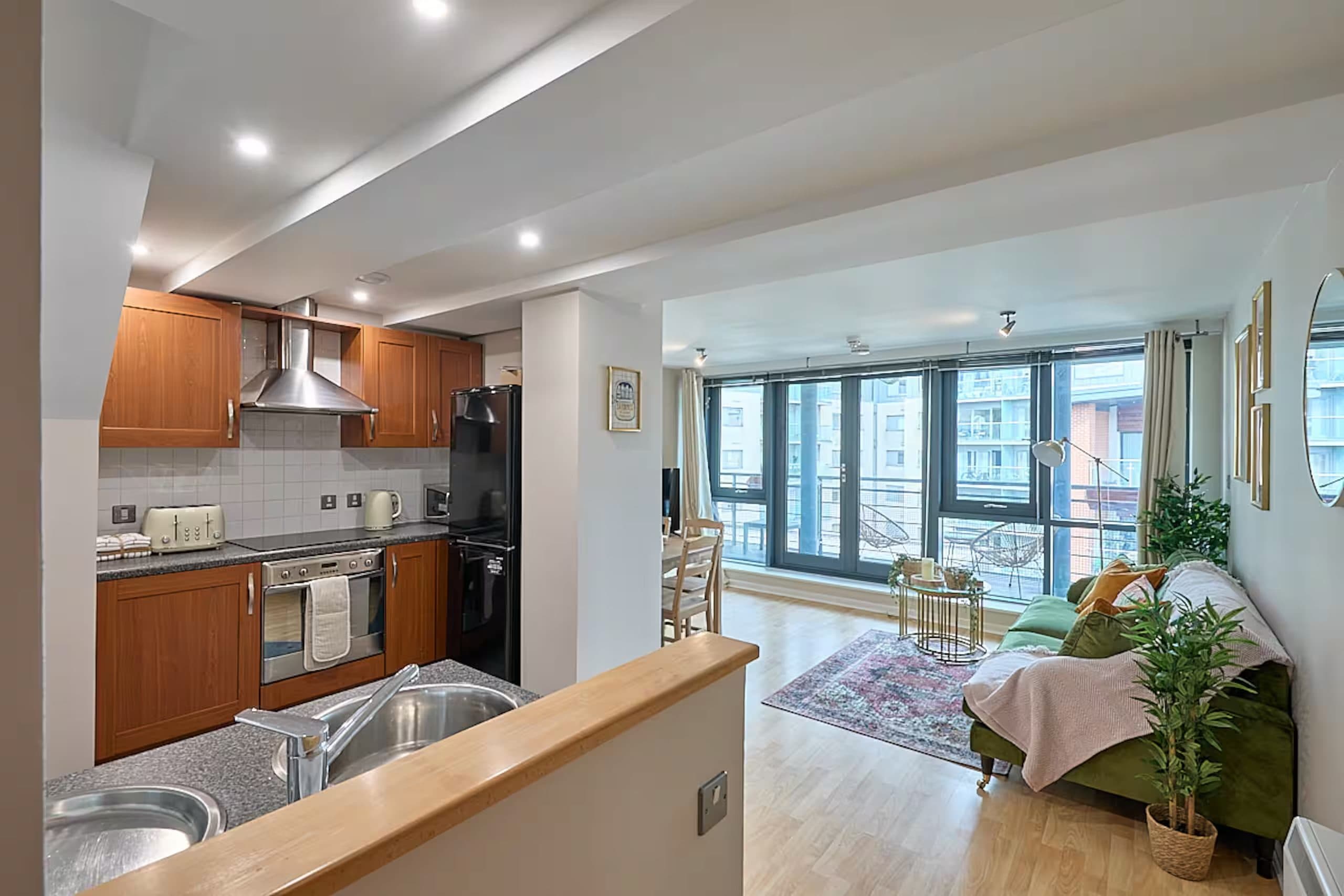 The open-plan kitchen and living area of the Deansgate apartment, reset for a guest