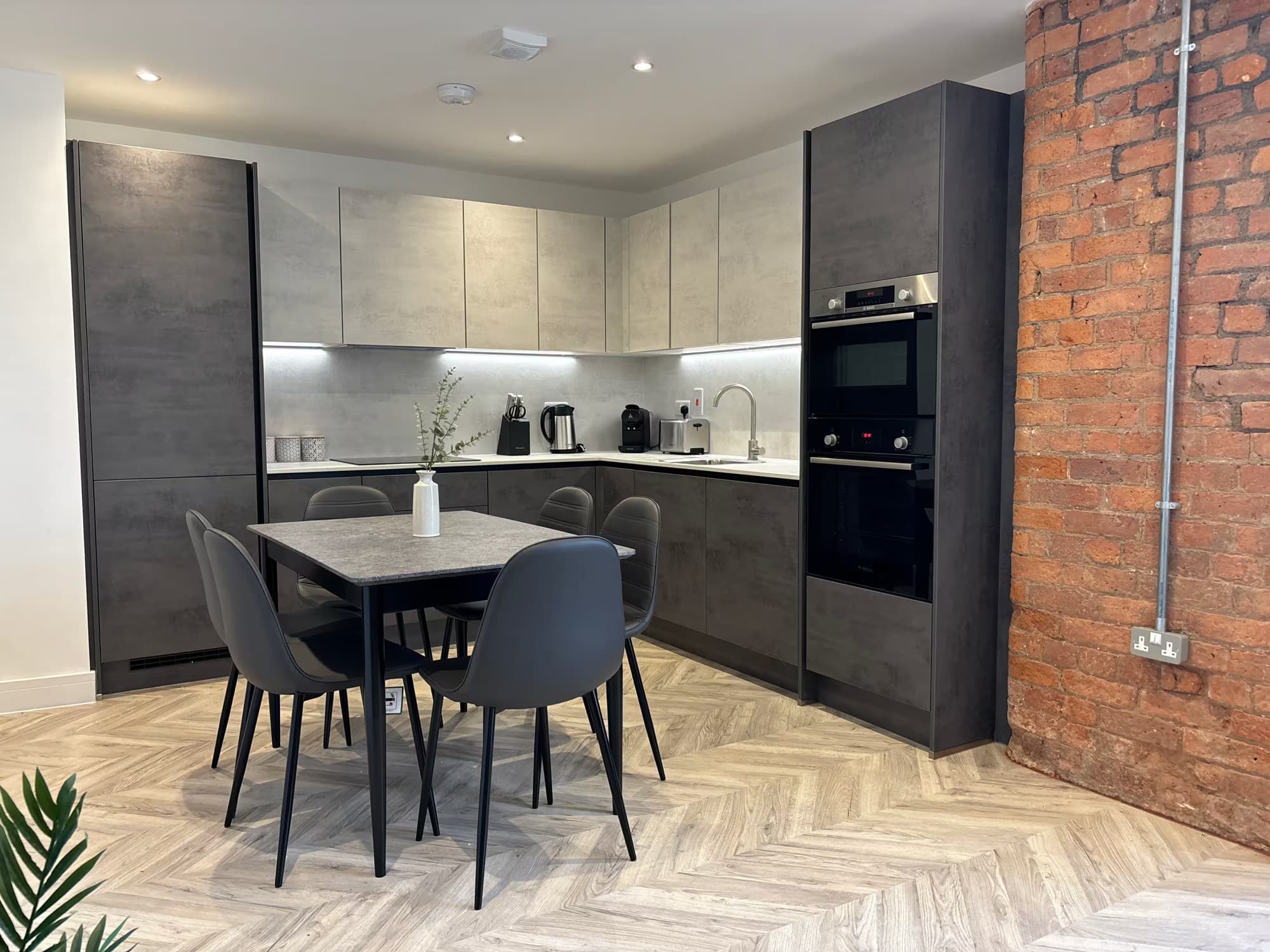 The open-plan kitchen and dining area of one of James’s apartments, reset for the next guest