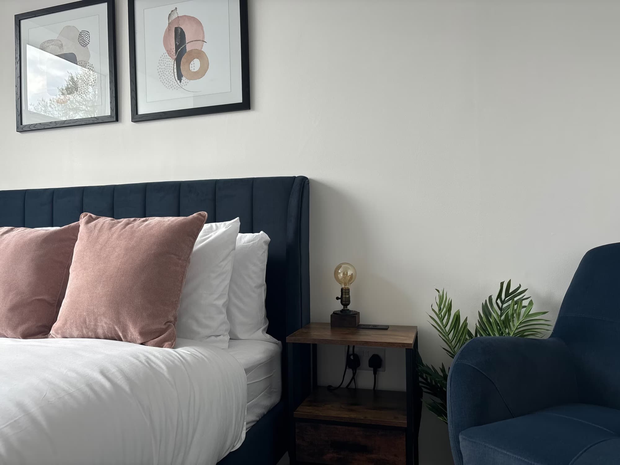 A bedroom in one of James’s apartments made up for arrival, with pressed white linen and styled cushions